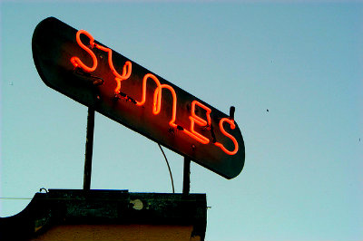 Red neon lights the sky above the Symes Hot Springs Hotel and Mineral Spa.